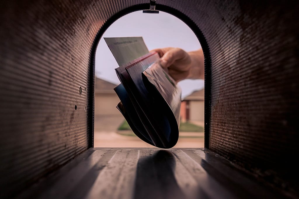 A man takes a document from the mailbox