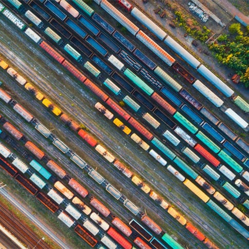 an aerial view of train cars on a train track.