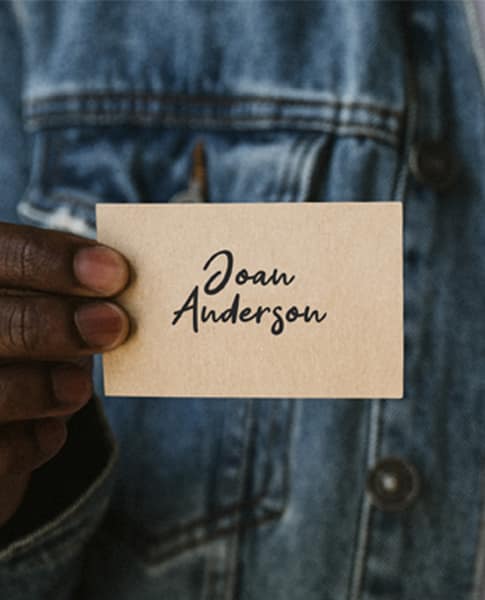 a man holding a business card with the name Daniel anderson.